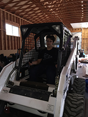 Owner demonstrating skid steer loader